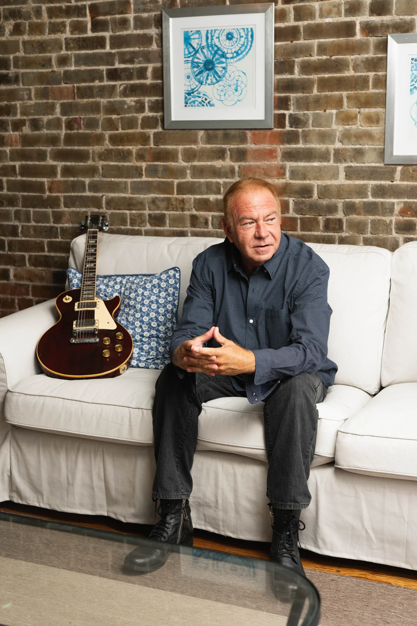 Dan Random seated with his guitar